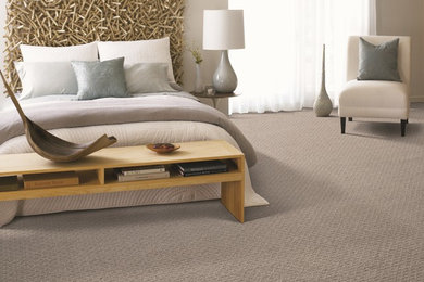 Example of a mid-sized trendy guest carpeted bedroom design in Seattle with beige walls and no fireplace