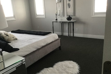 Mid-sized minimalist master carpeted bedroom photo in Toronto with gray walls