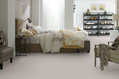 Example of a large trendy master carpeted bedroom design in Grand Rapids with gray walls