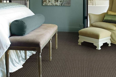 Example of a mid-sized trendy guest carpeted and brown floor bedroom design in Vancouver with blue walls