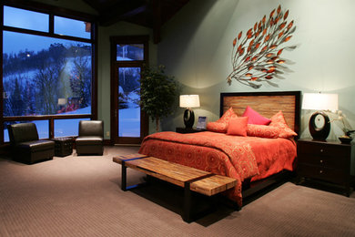 Example of a large trendy master carpeted bedroom design in Detroit with green walls and no fireplace