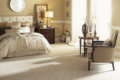 Large elegant master carpeted bedroom photo in Orange County with beige walls and no fireplace
