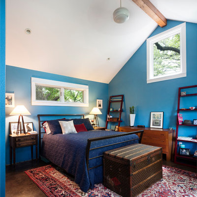 Example of a mid-sized trendy master concrete floor bedroom design in Austin with blue walls