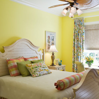 Example of an island style bedroom design in Miami with yellow walls