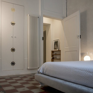 Foto de dormitorio principal y abovedado, mediterráneo, con suelo de cemento y suelo multicolor