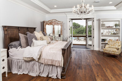 Large mountain style master medium tone wood floor bedroom photo in Tampa
