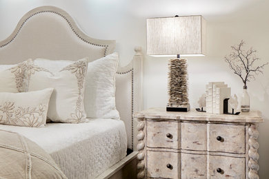 Medium sized coastal guest bedroom with beige walls, dark hardwood flooring and brown floors.