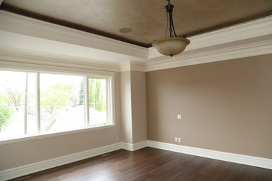 Inspiration for a large timeless master medium tone wood floor bedroom remodel in Edmonton with beige walls