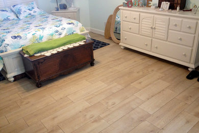 Example of a mid-sized beach style master ceramic tile and beige floor bedroom design in Orlando with blue walls