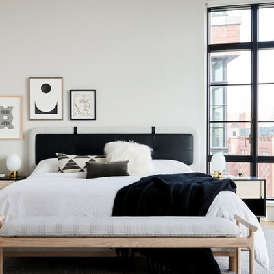 Bedroom - scandinavian master light wood floor bedroom idea in New York with white walls and no fireplace