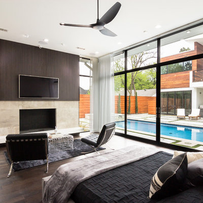 Inspiration for a large contemporary master dark wood floor and brown floor bedroom remodel in Dallas with a standard fireplace and a tile fireplace