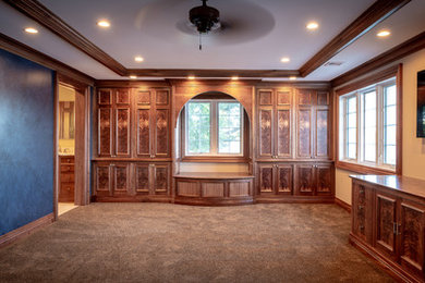 Example of a large tuscan master carpeted and brown floor bedroom design in Indianapolis with multicolored walls and no fireplace