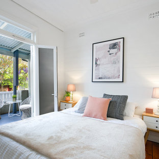 Design ideas for a transitional bedroom in Sydney with white walls, dark hardwood floors and brown floor.