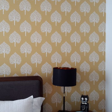 Cheery wallpaper accent wall in the master bedroom