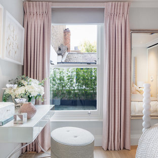 Photo of a medium sized traditional bedroom in London with grey walls, light hardwood flooring and brown floors.