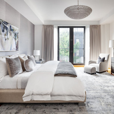 Danish master medium tone wood floor bedroom photo in New York with gray walls and no fireplace