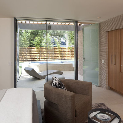 Example of a minimalist bedroom design in Austin with white walls