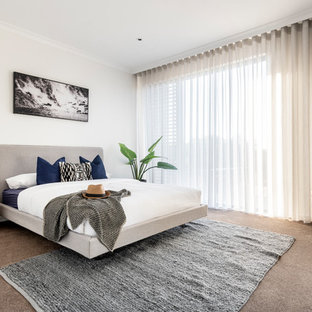 Inspiration for a contemporary bedroom in Perth with white walls, carpet and beige floor.