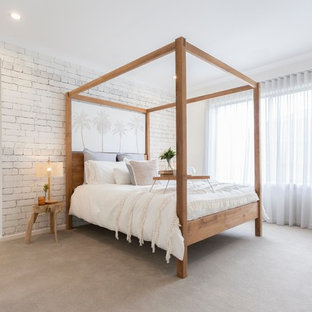 Inspiration for a beach style bedroom in Melbourne with white walls, carpet and beige floor.