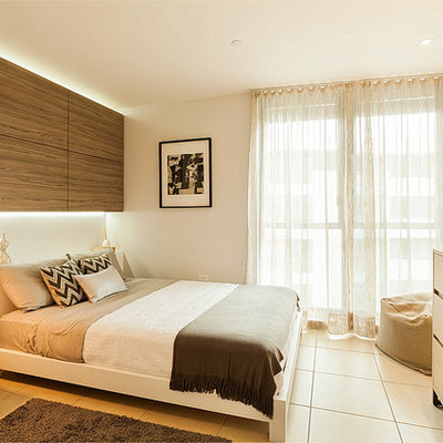 Small trendy master porcelain tile bedroom photo in Other with gray walls and no fireplace