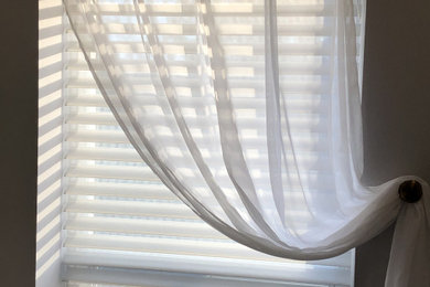 Classic window treatment with motorized shades behind