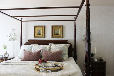 Photo of a medium sized traditional master bedroom in New York with beige walls and dark hardwood flooring.