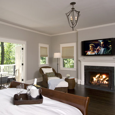 Bedroom - mid-sized traditional master dark wood floor and brown floor bedroom idea in New York with gray walls, a standard fireplace and a stone fireplace