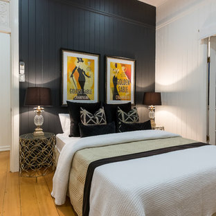 Beach style guest bedroom in Brisbane with white walls, light hardwood floors and beige floor.