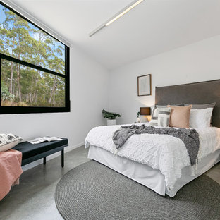 This is an example of a large contemporary master bedroom in Hobart with white walls, concrete floors and grey floor.