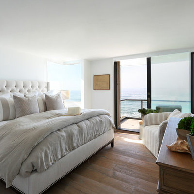 Example of a mid-sized beach style master dark wood floor and brown floor bedroom design in Santa Barbara with white walls and no fireplace