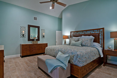 Example of a mid-sized beach style master porcelain tile bedroom design in Miami with blue walls