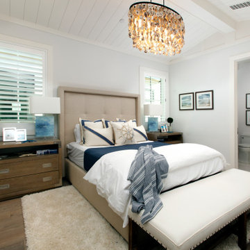 Coastal style blue guest bedroom with white accents and a nickel gap shiplap cei