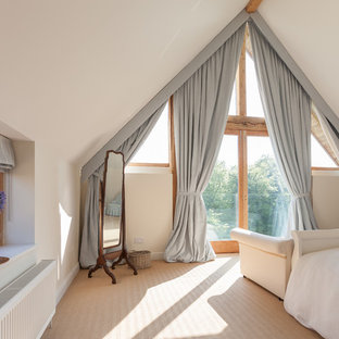 Contemporary bedroom in Gloucestershire with white walls and carpet.
