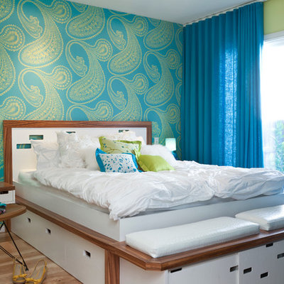 Example of a transitional light wood floor bedroom design in Other with multicolored walls