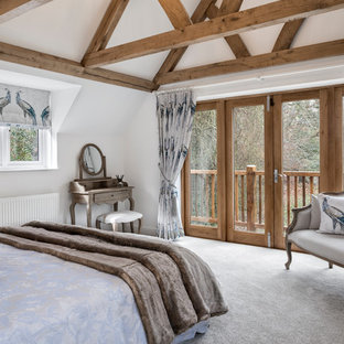 This is an example of a rustic guest bedroom in Berkshire with white walls, carpet and white floors.