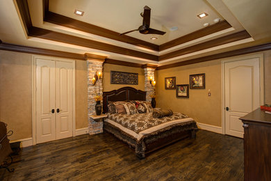 Design ideas for an expansive traditional master bedroom in Dallas with beige walls, dark hardwood flooring and no fireplace.