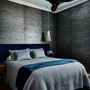 Contemporary bedroom in Sydney with grey walls, medium hardwood floors and brown floor.