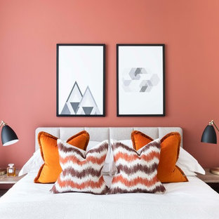 Contemporary bedroom in London with orange walls.