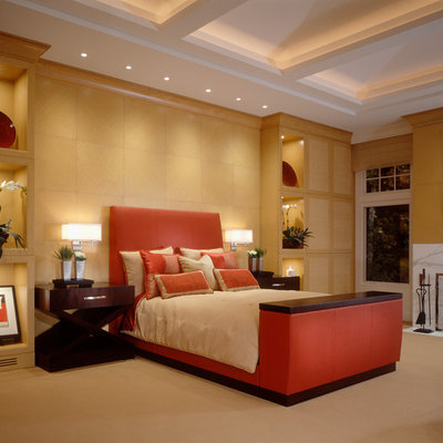 Example of a large trendy master carpeted and beige floor bedroom design in Cleveland with beige walls, a standard fireplace and a stone fireplace