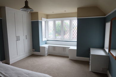 This is an example of a contemporary bedroom in Sussex.