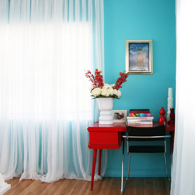 Inspiration for a contemporary medium tone wood floor bedroom remodel in Miami with blue walls