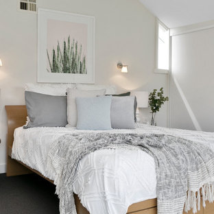 Inspiration for a contemporary bedroom in Hobart with white walls and black floor.