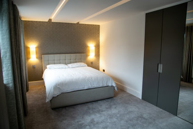 This is an example of a medium sized contemporary guest bedroom in Other with white walls, carpet, no fireplace and grey floors.