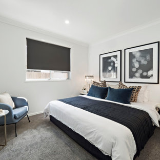 This is an example of a mid-sized contemporary master bedroom in Brisbane with grey walls, carpet and grey floor.