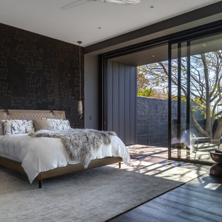Photo of a contemporary master bedroom in Melbourne with brown floor, black walls and dark hardwood floors.