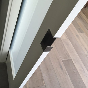 contemporary pocket door hardware at white oak flooring