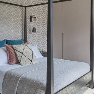 Design ideas for a contemporary master bedroom in Hertfordshire with multi-coloured walls, carpet, no fireplace and grey floors.