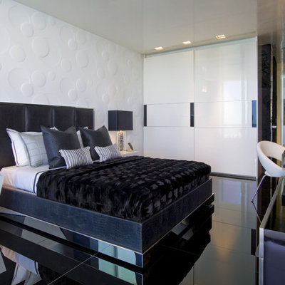 Inspiration for a modern ceramic tile and black floor bedroom remodel in Miami with white walls and no fireplace