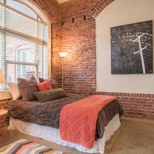 Modelo de dormitorio industrial con paredes rojas y suelo de cemento
