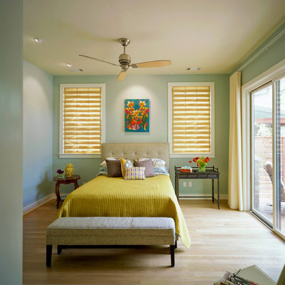 Inspiration for a contemporary light wood floor bedroom remodel in Austin with green walls